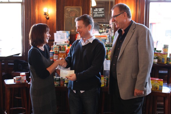 Frenzi Group director Brian Collins (centre) hands over a generous donation to Auckland City Missioner Diane Robertson while Kevin Schwass (right), owner of Blankenberge, looks on. 